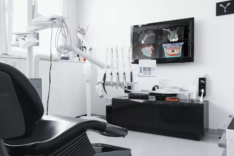 Dentist's Chair with DTX Studio showing a CBCT and X-Ray Pictures